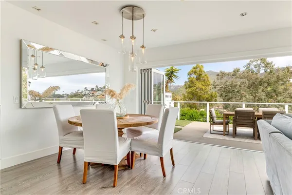 a view of a dining room with furniture window and wooden floor