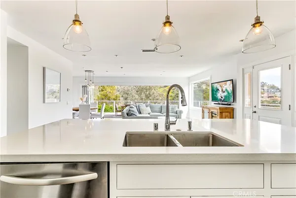 a kitchen with a large window and a chandelier