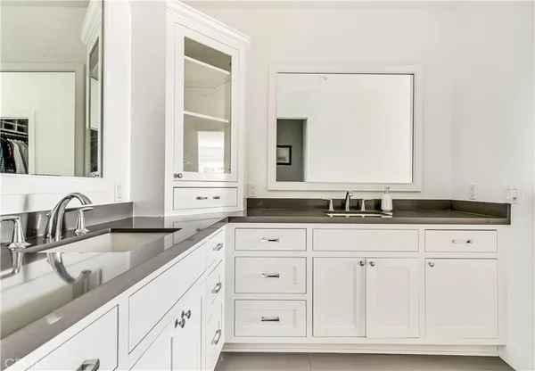 a bathroom with double sink and a mirror