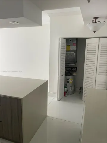 a kitchen with a refrigerator and cabinets