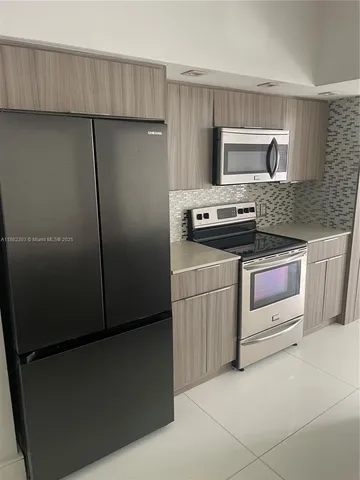 a kitchen with a stove and a refrigerator