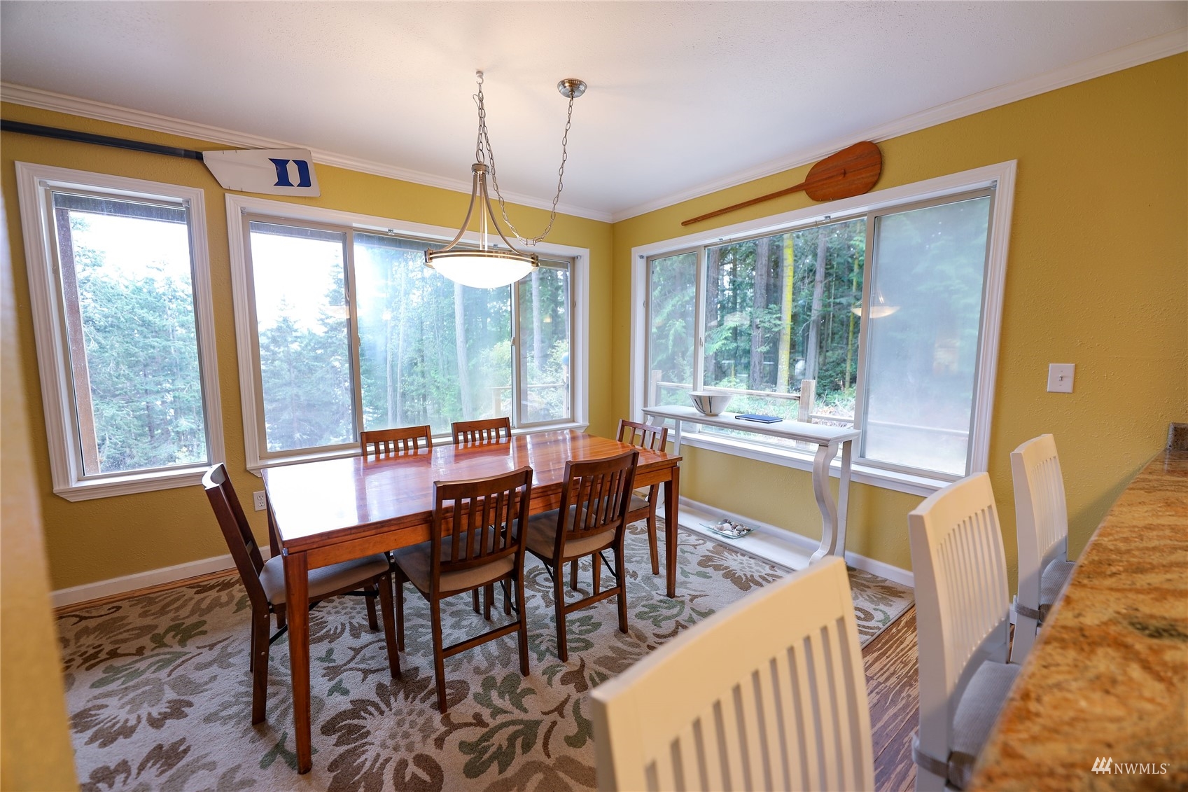 208 Reed Bay Road Decatur Island, WA 98221 - Photo 13 of 33 a dining room with furniture a chandelier and wooden floor