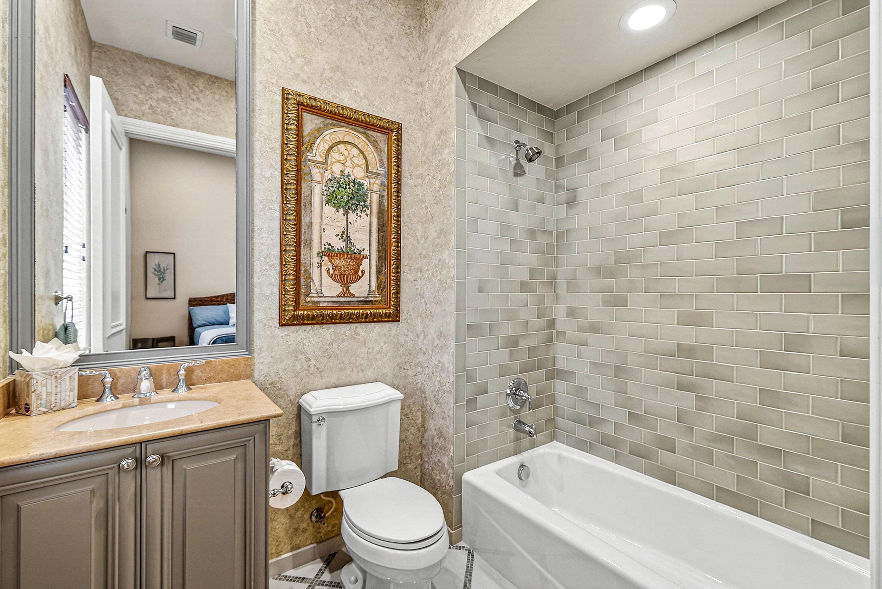 6445 Montesito Street Boca Raton, FL 33496 - Photo 31 of 86 a bathroom with a toilet a sink a mirror a bathtub and shower