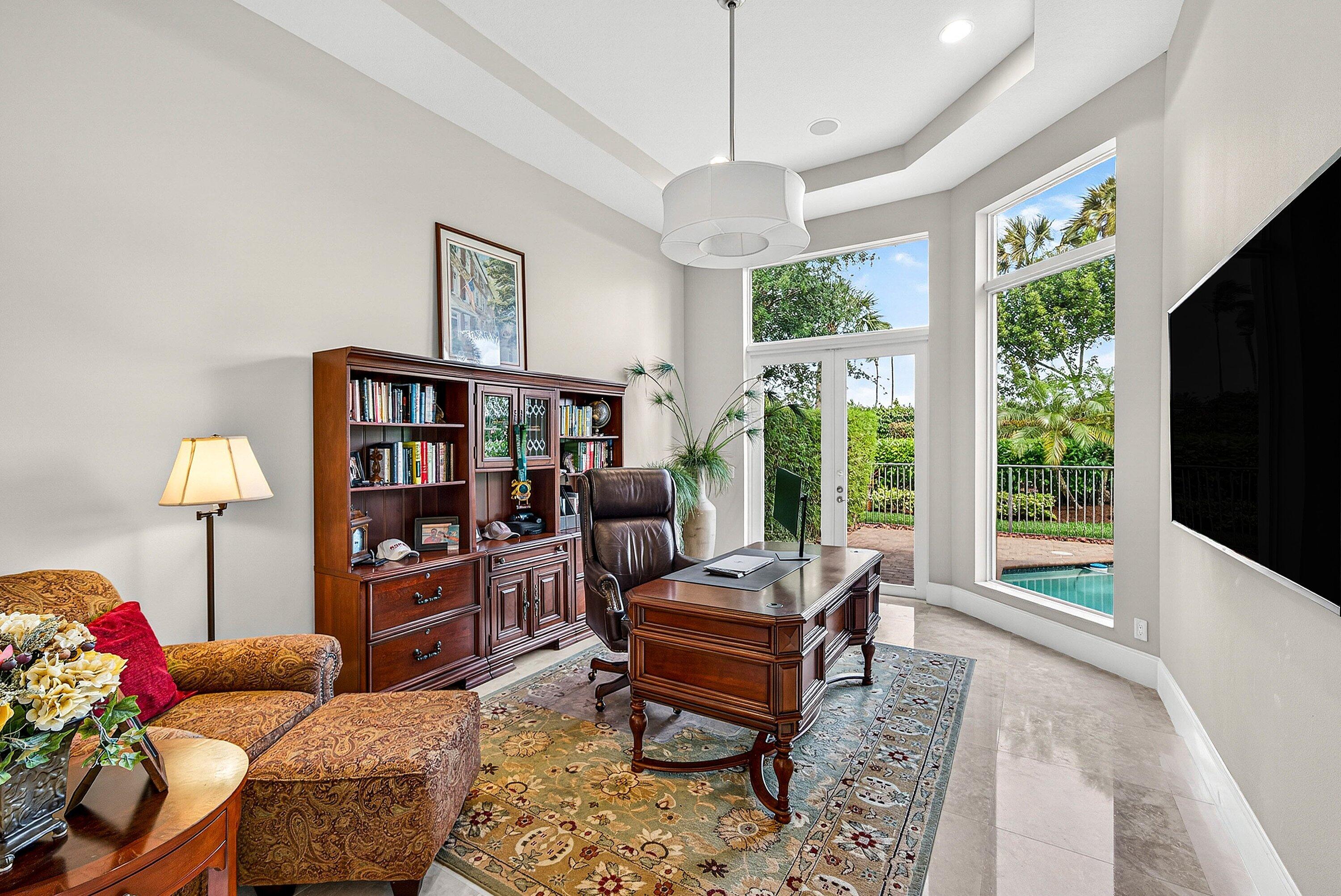 6445 Montesito Street Boca Raton, FL 33496 - Photo 83 of 86 a living room with furniture a flat screen tv and a floor to ceiling window