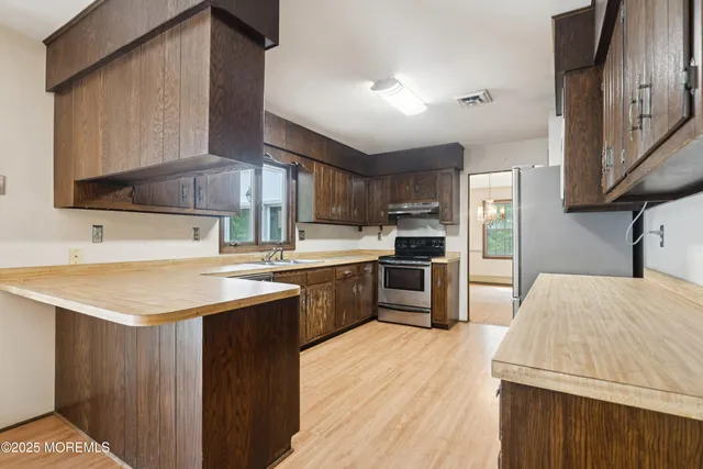 a kitchen with a sink refrigerator and a microwave oven