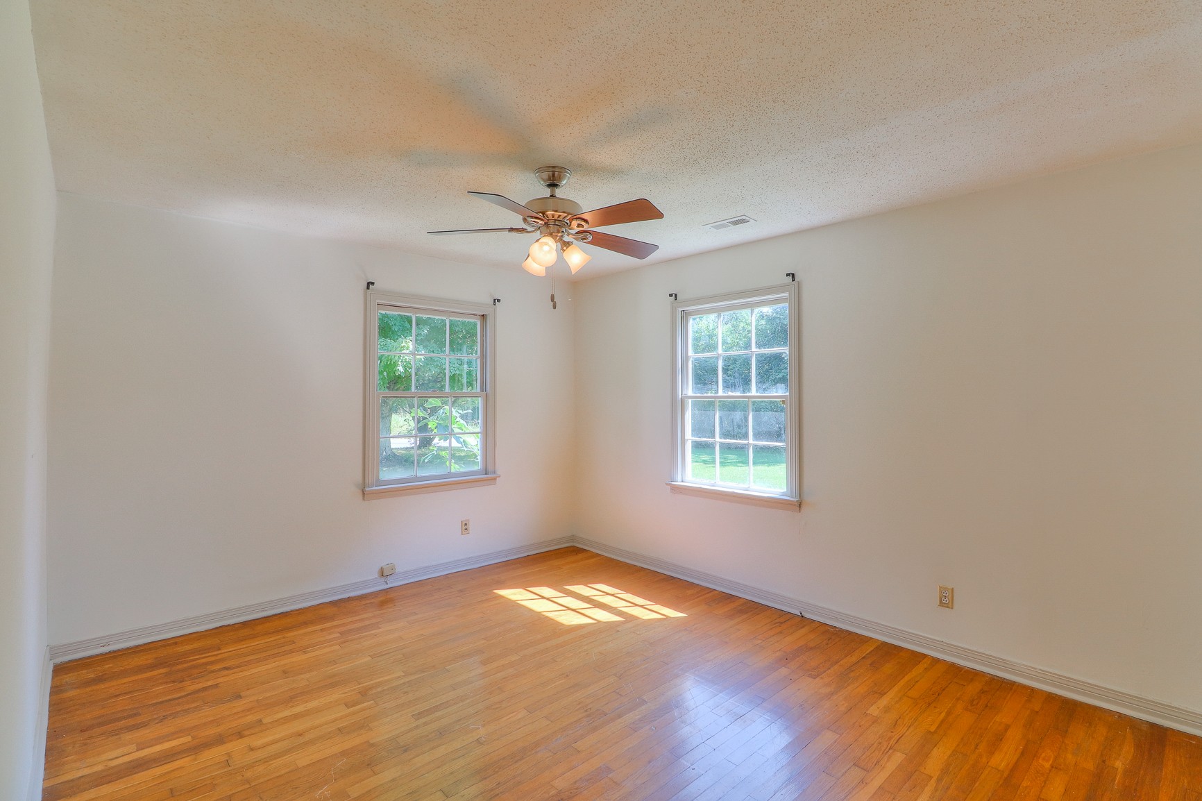 3308 Craig Bridge Road Williamsport, TN 38487 - Photo 16 of 45 a view of empty room with wooden floor and fan