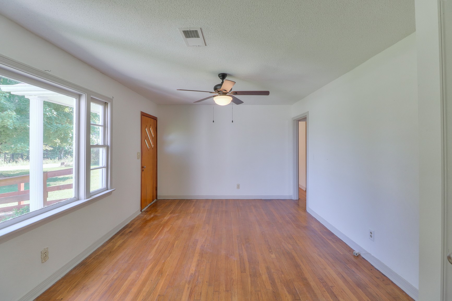 3308 Craig Bridge Road Williamsport, TN 38487 - Photo 20 of 45 a view of an empty room with wooden floor and a window
