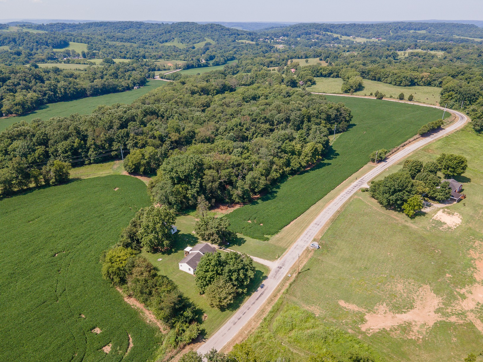 3308 Craig Bridge Road Williamsport, TN 38487 - Photo 38 of 45 an aerial view of green landscape with trees houses and mountain view
