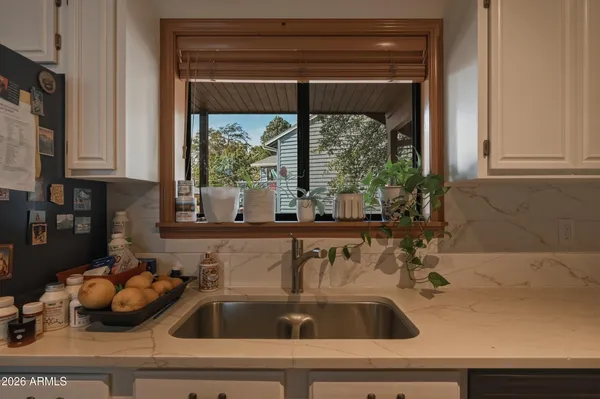 a kitchen with a sink appliances and cabinets