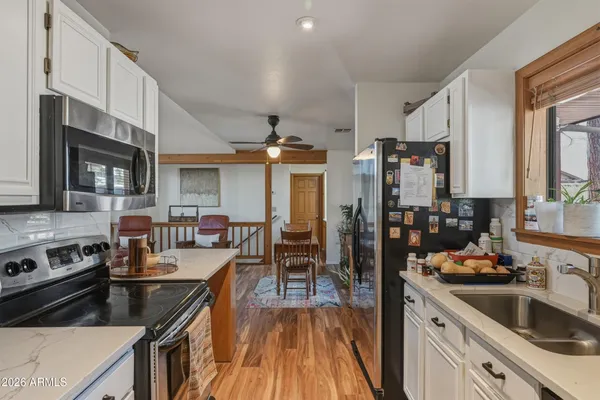 a kitchen with granite countertop lots of counter top space a sink and appliances