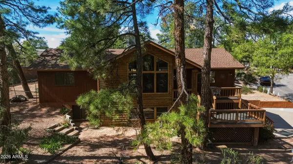 a front view of a house with a tree