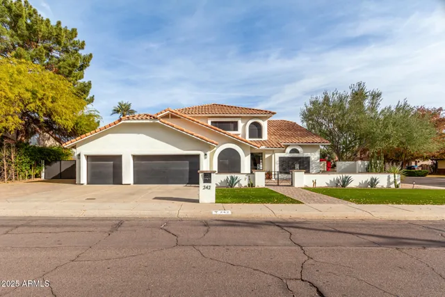 a front view of a house with a yard and trees