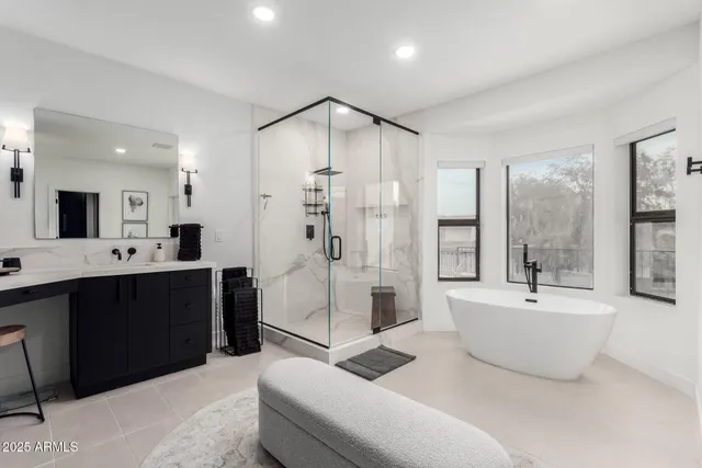 a spacious bathroom with a double vanity sink a mirror and a bathtub