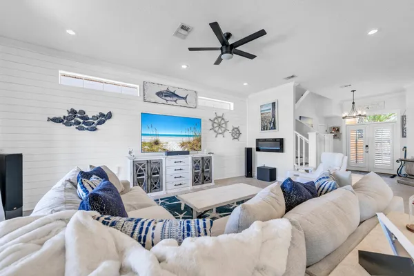 a kitchen with stainless steel appliances granite countertop white cabinets a sink and dishwasher a stove top oven with wooden floor