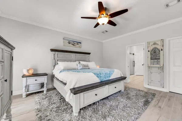 a spacious bedroom with a bed and a chandelier