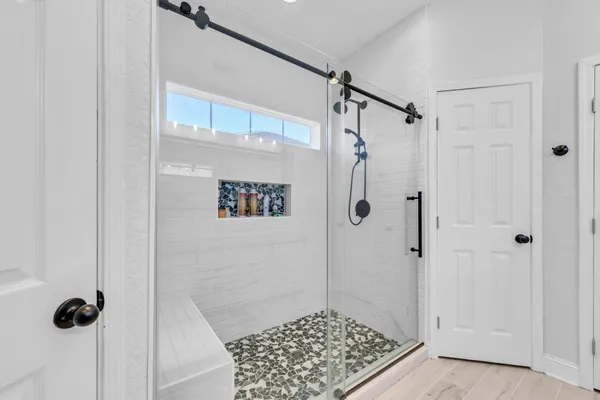a bathroom with a granite countertop sink toilet and mirror