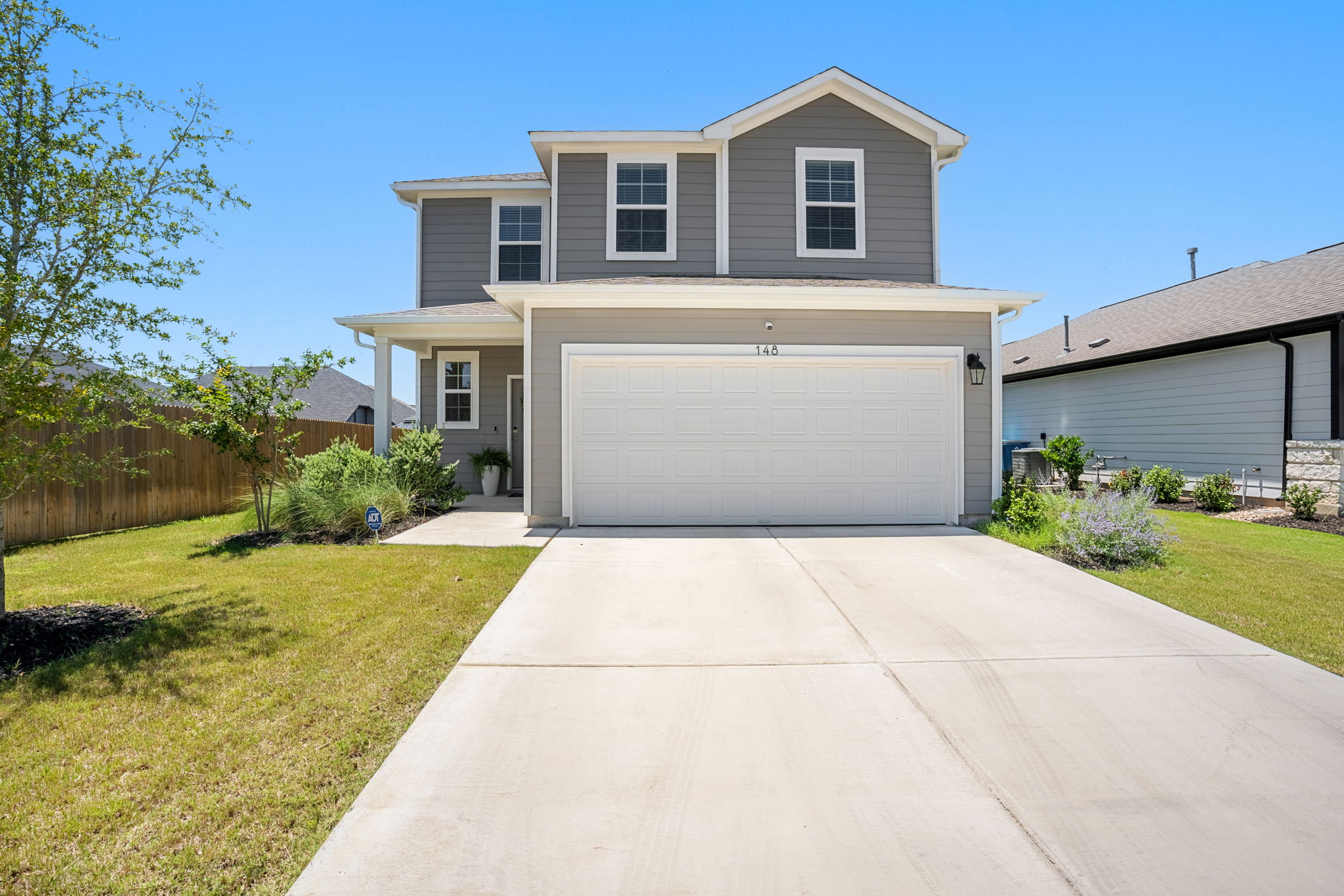 A well-maintained two-story home with a neat driveway and welcoming front​​‌​​​​‌​​‌‌​‌‌​​‌​​​​‌​​​‌‌​‌‌‌ landscaping.