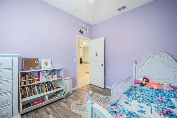 a bedroom with furniture and a book shelf