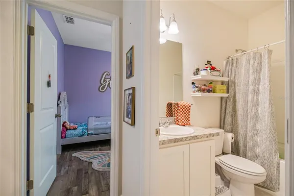a en suite bathroom with a sink toilet and shower curtain