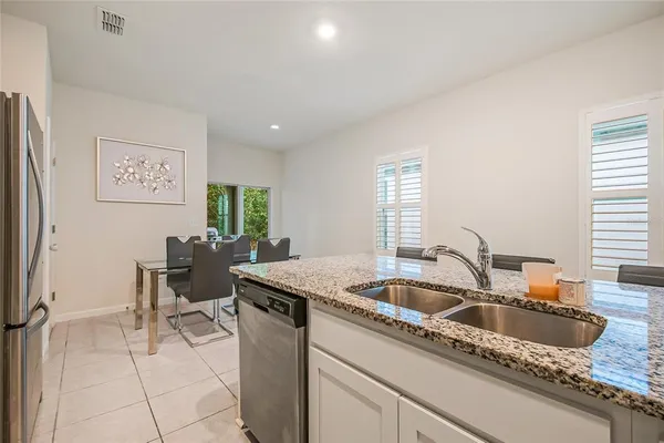 a kitchen with a sink cabinets and window