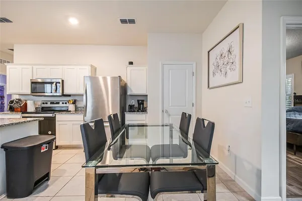 a view of kitchen with furniture and stainless steel appliances