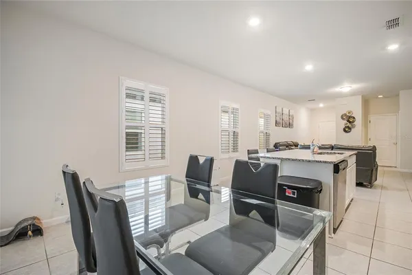 a dining room with furniture and window