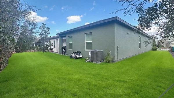 a view of backyard with barbeque oven and garden