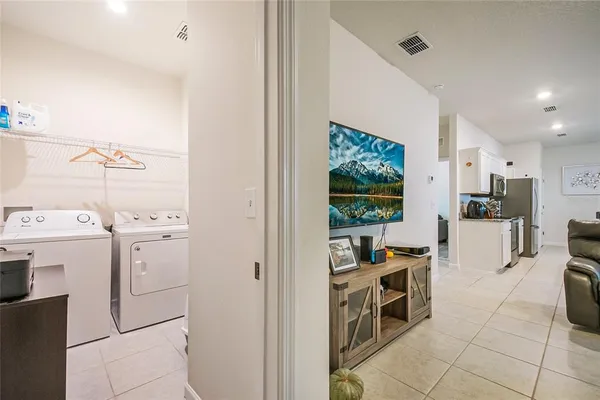 a kitchen with a refrigerator and a stove top oven