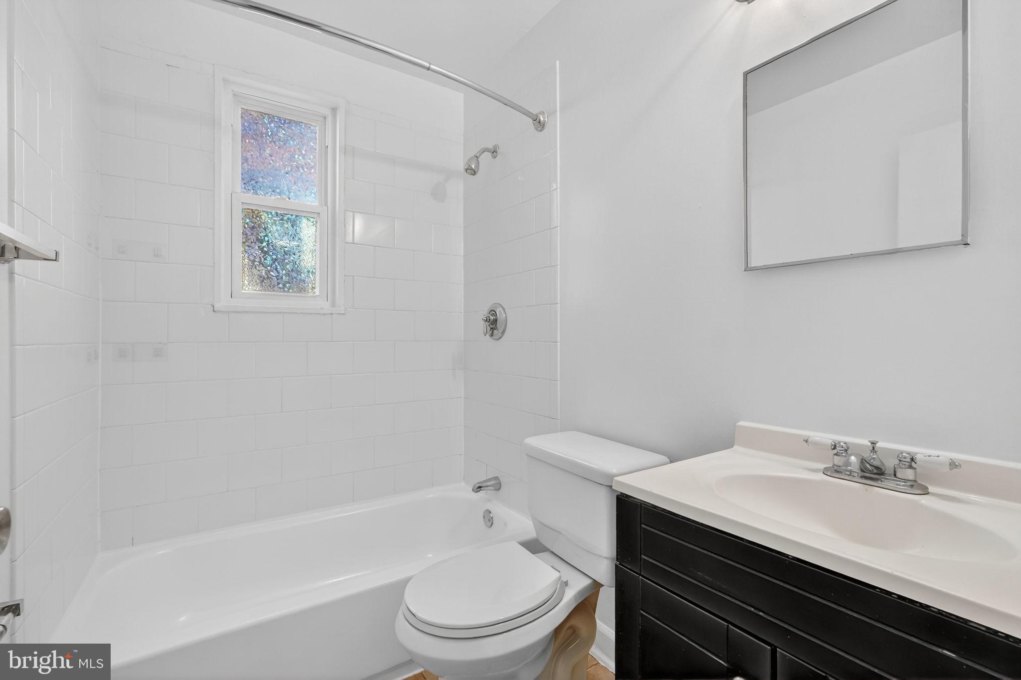 2523 13th Street Northwest, Unit 305 Washington, DC 20009 - Photo 16 of 29 a bathroom with a sink a toilet and shower