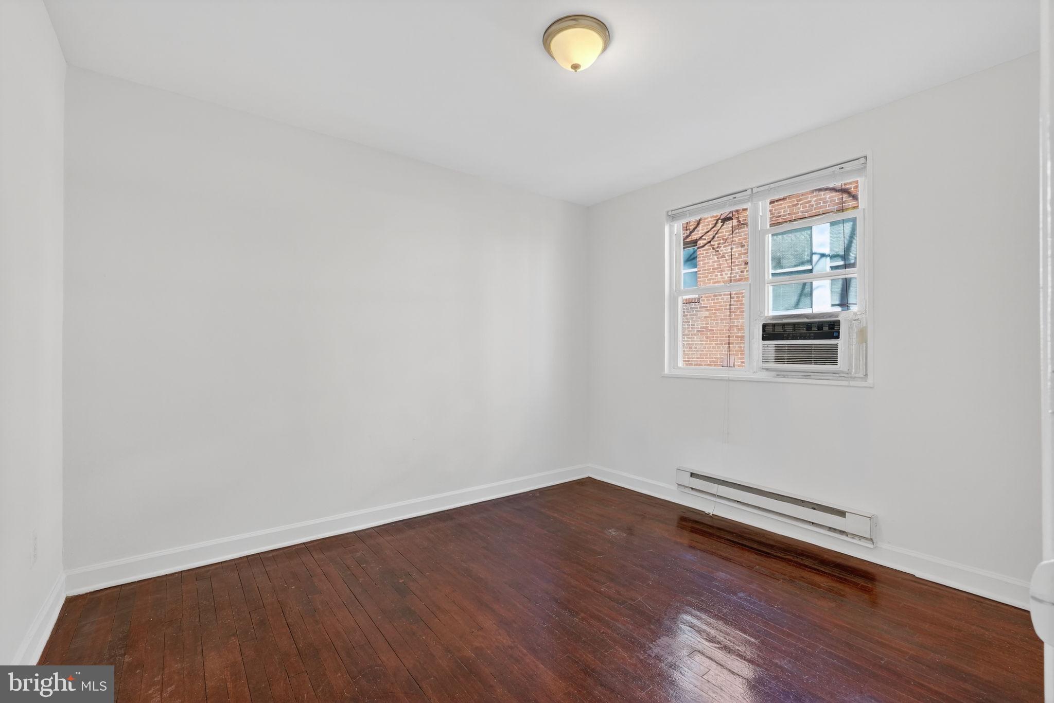 2523 13th Street Northwest, Unit 305 Washington, DC 20009 - Photo 17 of 29 a view of a room with wooden floor and windows