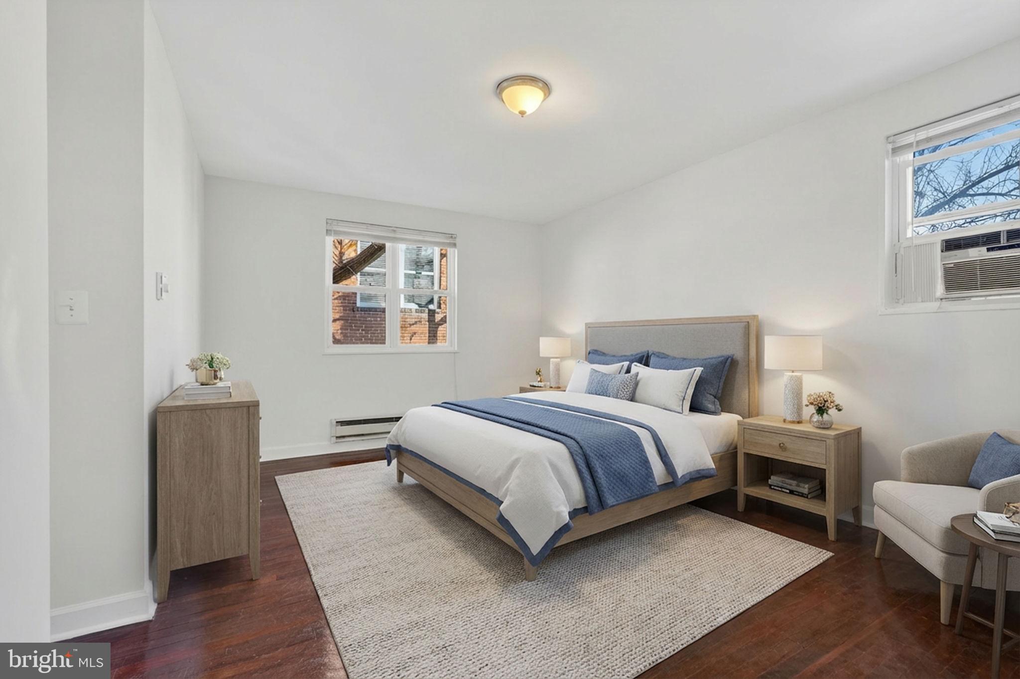 2523 13th Street Northwest, Unit 305 Washington, DC 20009 - Photo 19 of 29 a spacious bedroom with a bed and a couch