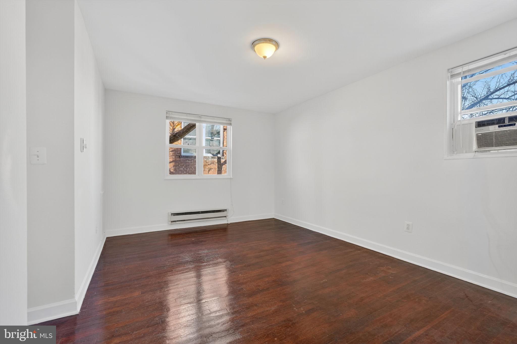 2523 13th Street Northwest, Unit 305 Washington, DC 20009 - Photo 20 of 29 an empty room with wooden floor and windows
