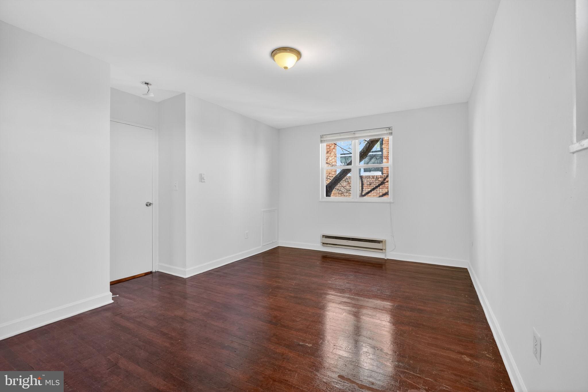2523 13th Street Northwest, Unit 305 Washington, DC 20009 - Photo 21 of 29 an empty room with wooden floor and window