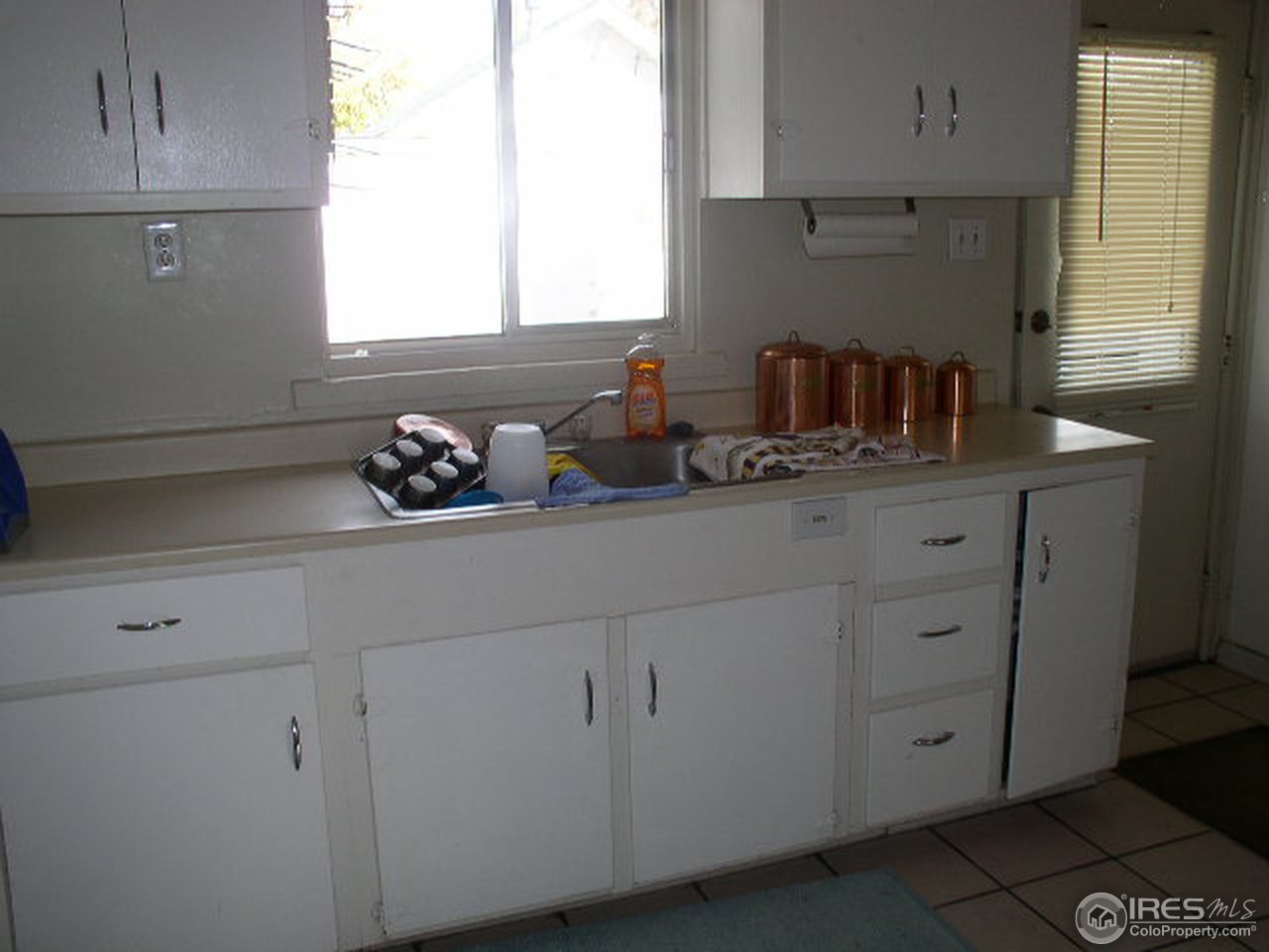 104 West Baseline Road Lafayette, CO 80026 - Photo 16 of 16 a kitchen with cabinets and window