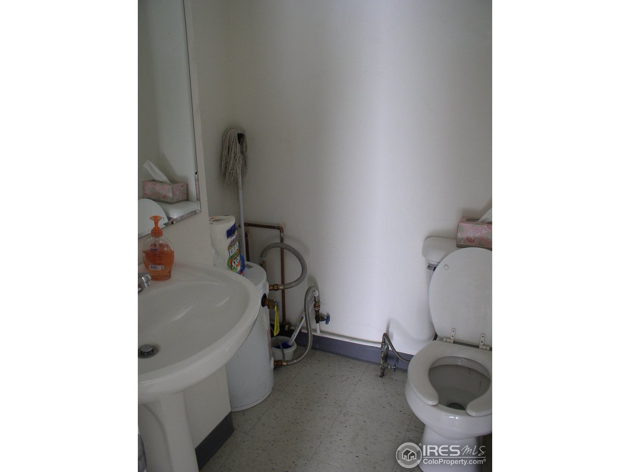 104 West Baseline Road Lafayette, CO 80026 - Photo 10 of 16 a bathroom with a sink and a toilet