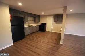 a kitchen with a refrigerator and a stove top oven