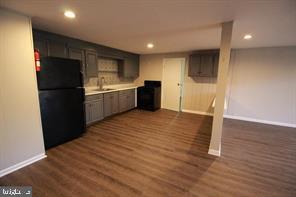 a kitchen with a refrigerator and a stove top oven