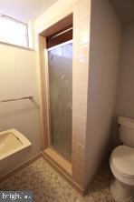 424 Trenton Road, Unit I Browns Mills, NJ 08015 - Photo 7 of 7 a bathroom with a granite countertop toilet and a shower