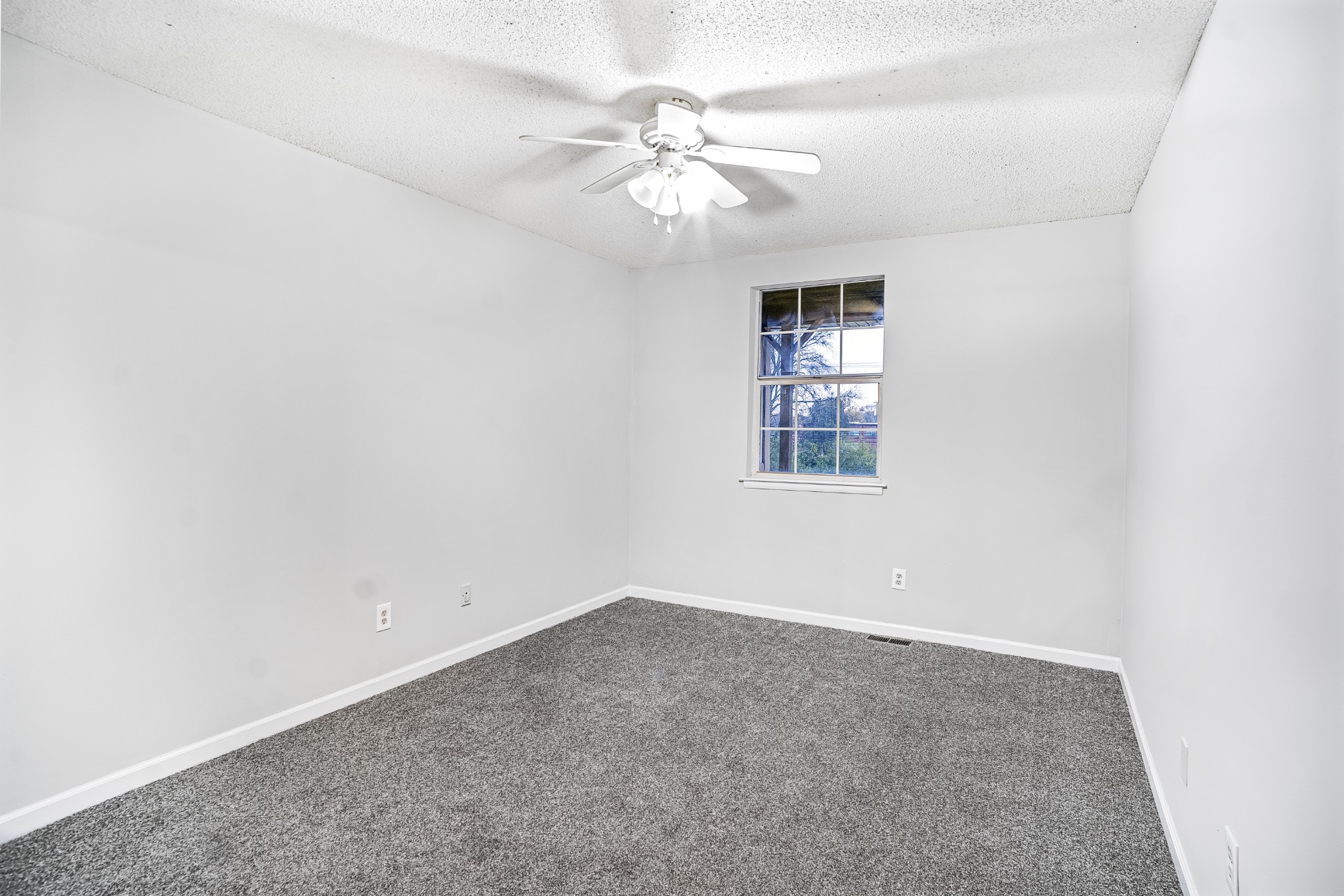 1301 Neelys Bend Road, Unit 9 Madison, TN 37115 - Photo 14 of 21 an empty room with a chandelier fan and windows