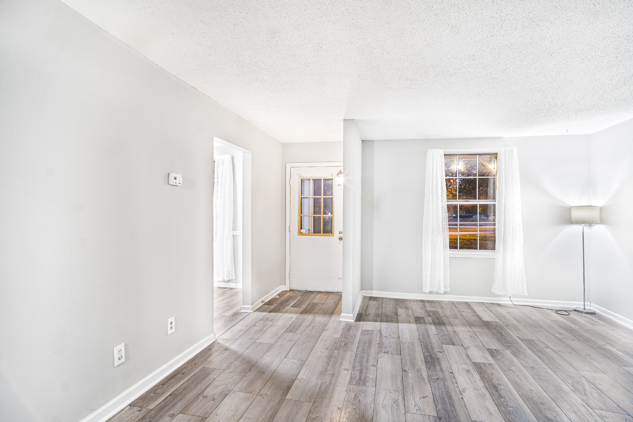 1301 Neelys Bend Road, Unit 9 Madison, TN 37115 - Photo 4 of 21 an empty room with wooden floor and windows