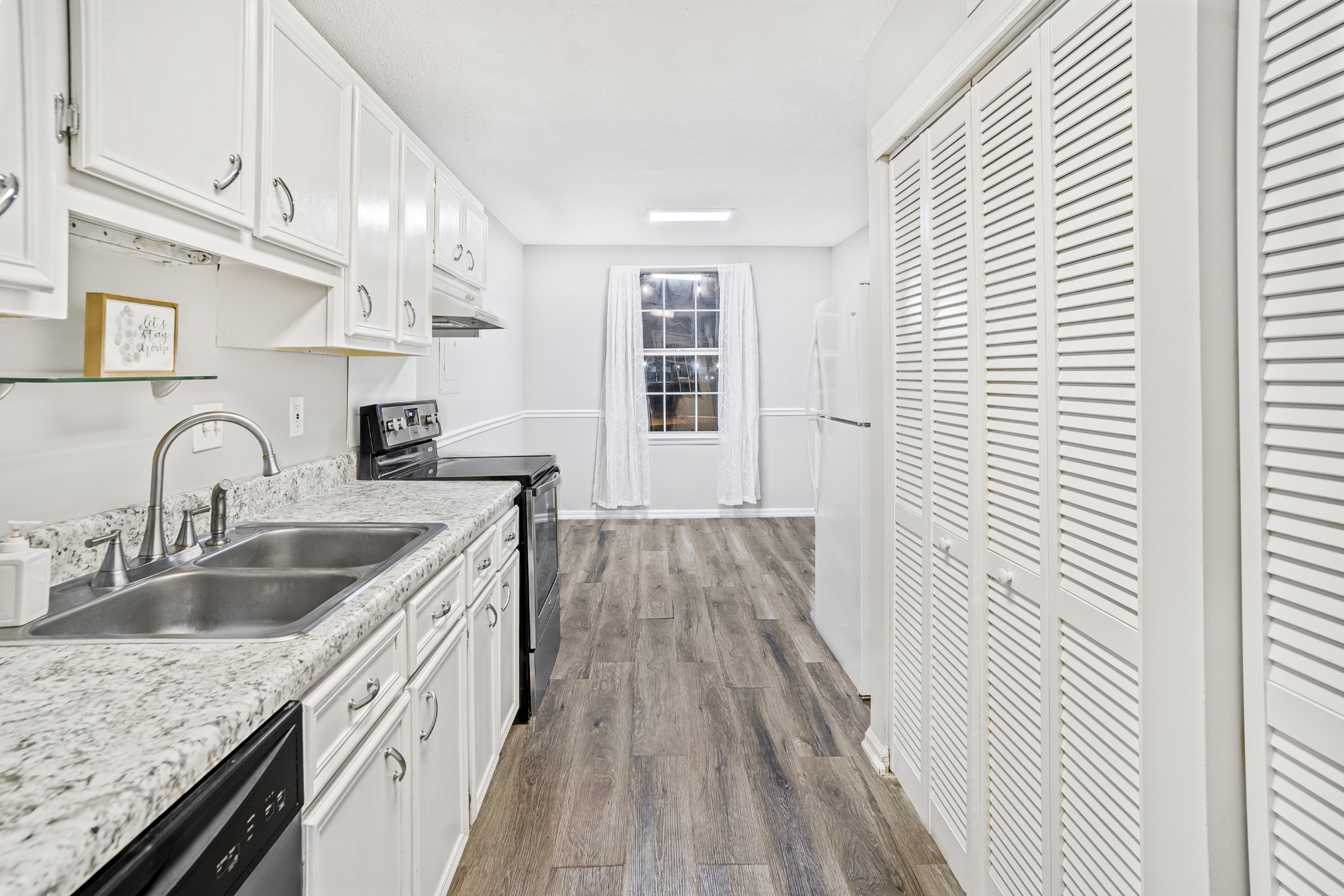 1301 Neelys Bend Road, Unit 9 Madison, TN 37115 - Photo 8 of 21 a kitchen with granite countertop a sink and wooden floor