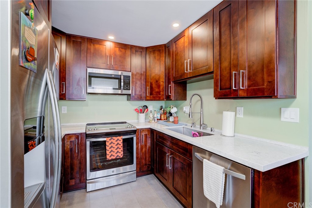 a kitchen with stainless steel appliances sink stove microwave and cabinets