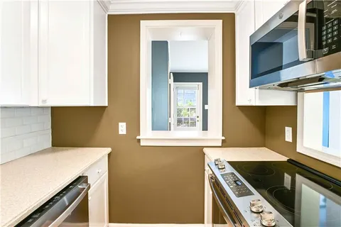 a kitchen with a stove and a microwave