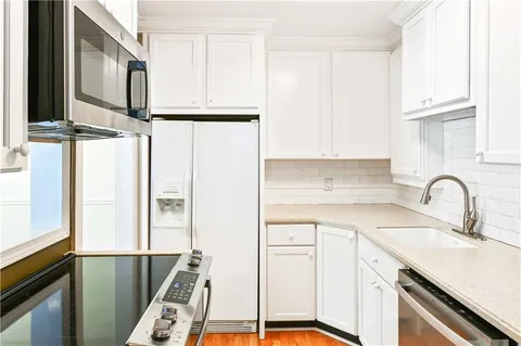 a kitchen with appliances cabinets and a sink