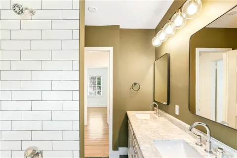a bathroom with a granite countertop sink and a mirror