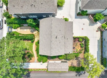 an aerial view of a house with a yard and potted plants