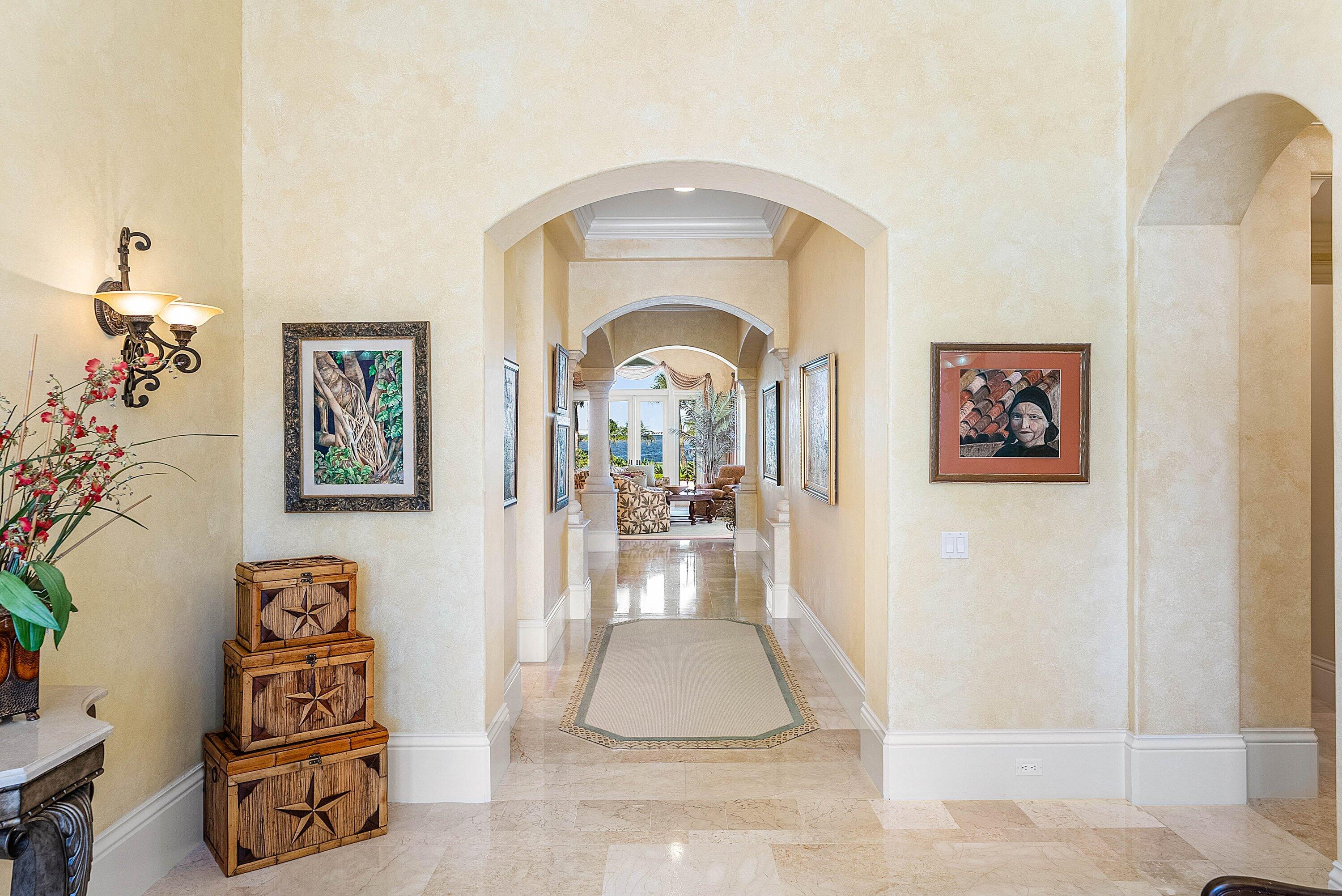 6381 Southeast Harbor Circle Stuart, FL 34996 - Photo 11 of 102 a view of a hallway with paintings on the wall