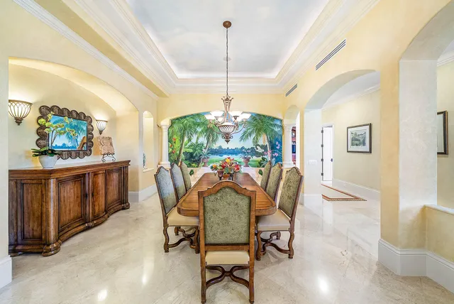 a living room with furniture kitchen view and a flat screen tv