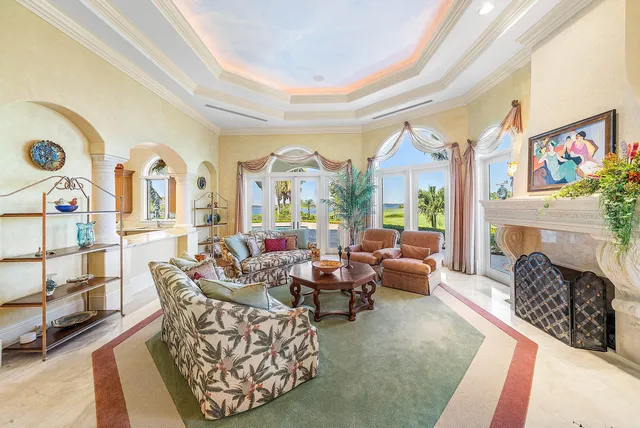 a living room with furniture a rug and a chandelier