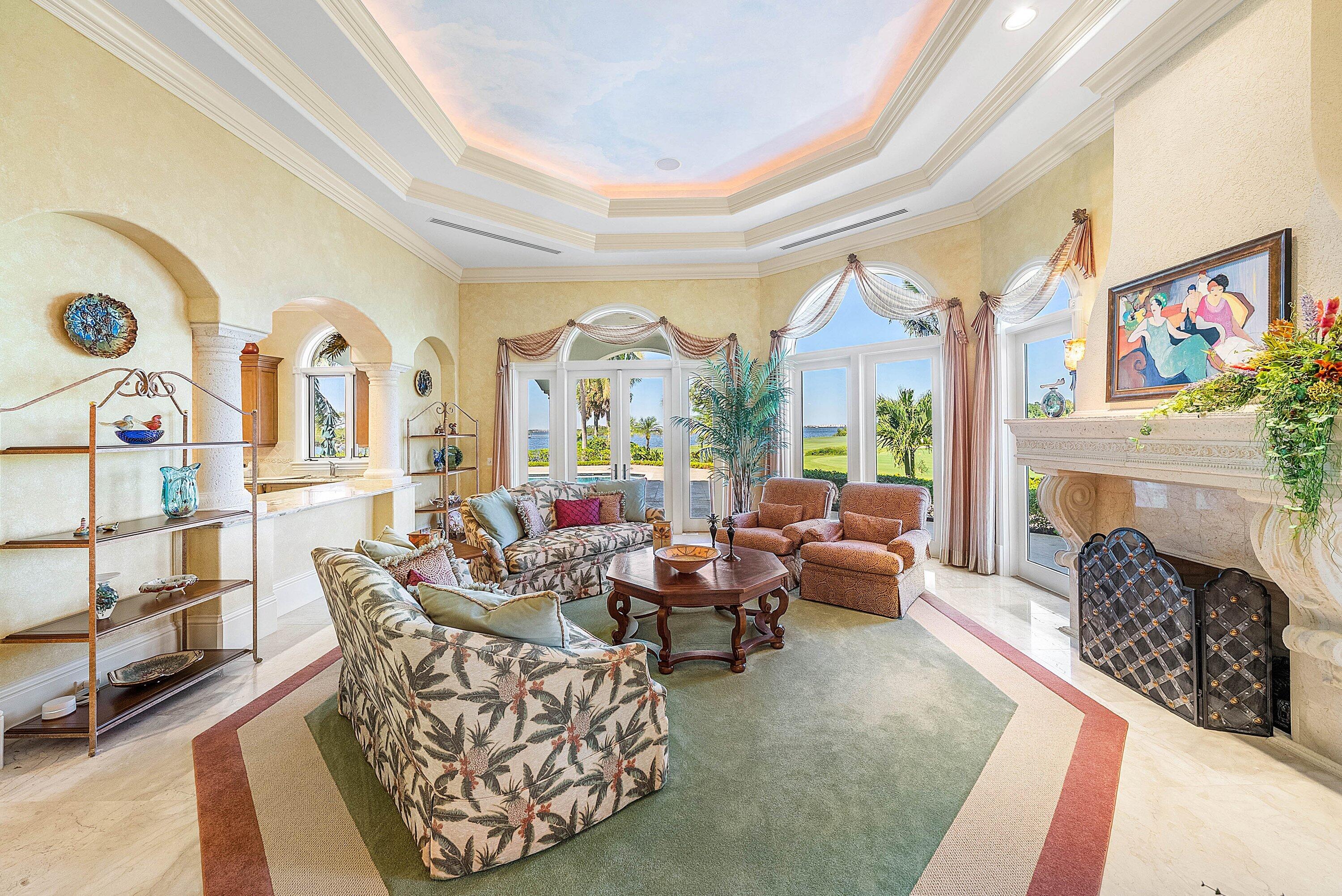 6381 Southeast Harbor Circle Stuart, FL 34996 - Photo 16 of 102 a living room with furniture a fireplace and a large window